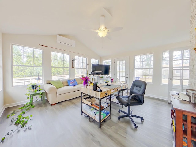 office space with lofted ceiling, an AC wall unit, a healthy amount of sunlight, and wood finished floors