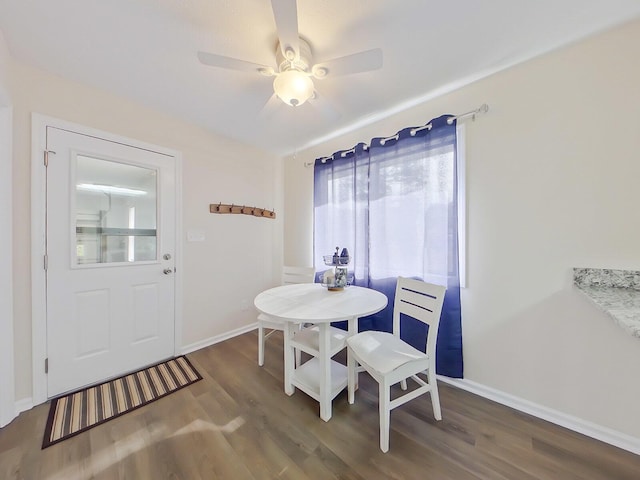dining area with ceiling fan, baseboards, and wood finished floors