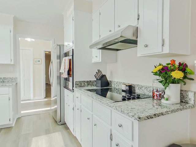 kitchen with white cabinets, stainless steel oven, under cabinet range hood, and black electric cooktop