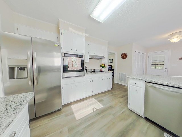 kitchen featuring light wood-type flooring, visible vents, appliances with stainless steel finishes, and white cabinets