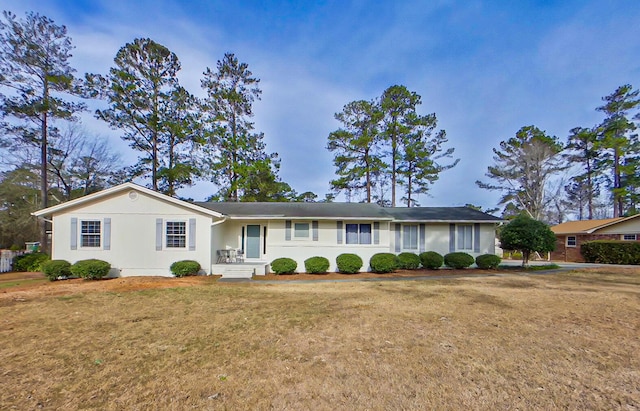 ranch-style house with a front lawn