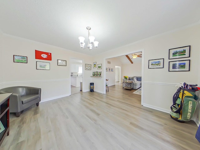living area featuring light wood-style flooring, baseboards, crown molding, and ceiling fan with notable chandelier