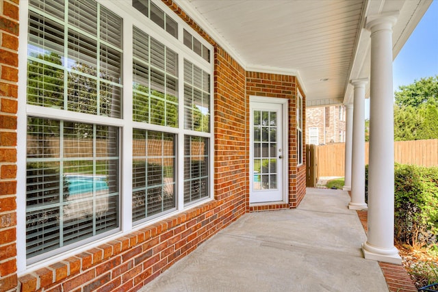 view of patio with covered porch and fence