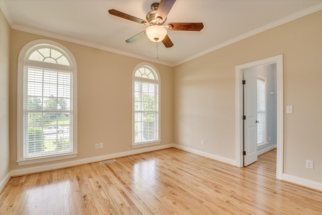 unfurnished room with light wood-style flooring, baseboards, and crown molding