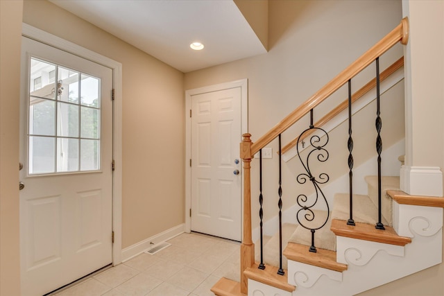 entryway with stairs, light tile patterned floors, baseboards, and recessed lighting
