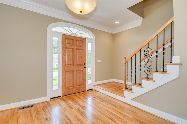 entrance foyer with wood finished floors, crown molding, baseboards, stairs, and recessed lighting