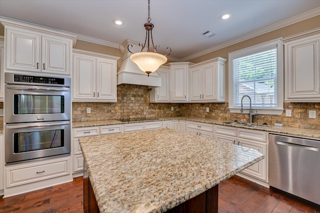 1164 Waltons Pass, Evans, GA 30809 - kitchen with appliances with stainless steel finishes, ornamental molding, light stone counters, dark wood-style flooring, and recessed lighting