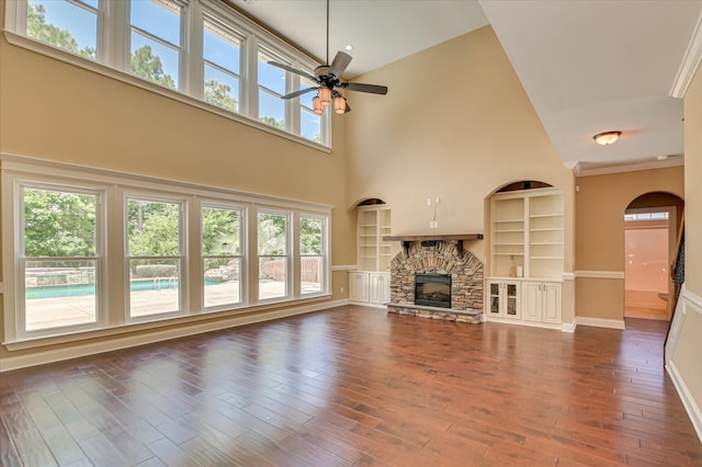 1164 Waltons Pass, Evans, GA 30809 - unfurnished living room with ceiling fan, built in shelves, a fireplace, dark wood finished floors, and a towering ceiling