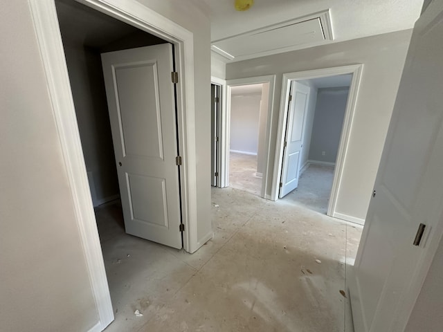 hall with attic access and baseboards