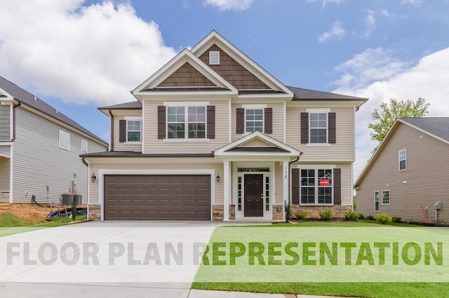 craftsman house with driveway, central AC unit, stone siding, an attached garage, and a front yard