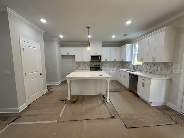 kitchen featuring decorative backsplash, crown molding, baseboards, appliances with stainless steel finishes, and white cabinetry