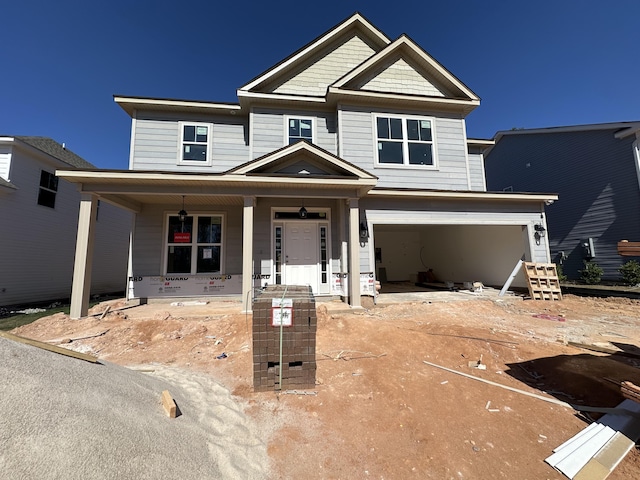 view of front of property with an attached garage and a porch