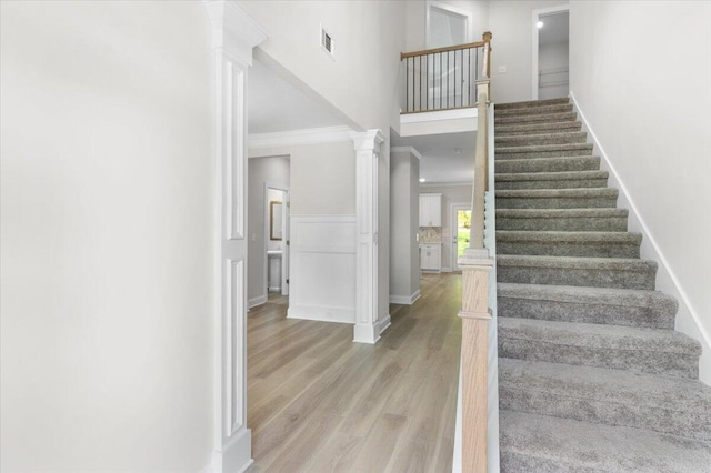 5085 Anna Way Unit Fb28, North Augusta, SC 29841 - stairs featuring ornamental molding, decorative columns, a high ceiling, and wood finished floors