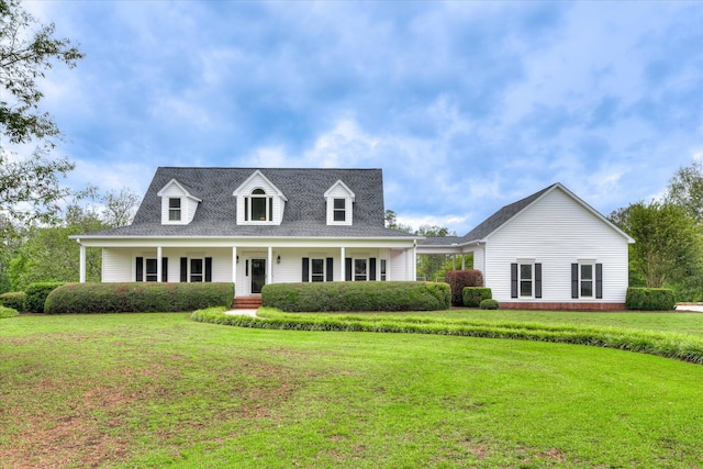 81 Two Mile Dr, Johnston, SC 29832 - cape cod-style house featuring a front yard and a porch