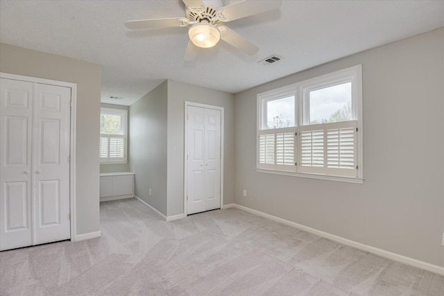 81 Two Mile Dr, Johnston, SC 29832 - unfurnished bedroom with multiple closets, light carpet, and ceiling fan