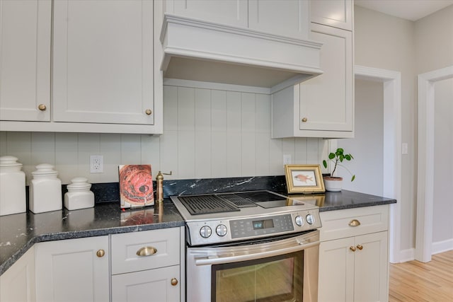 81 Two Mile Dr, Johnston, SC 29832 - kitchen featuring stainless steel range with electric cooktop, custom range hood, backsplash, and white cabinets