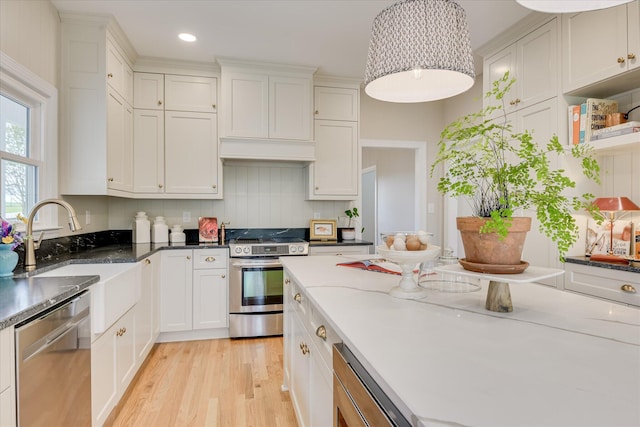 81 Two Mile Dr, Johnston, SC 29832 - kitchen with stainless steel appliances, light wood-type flooring, recessed lighting, white cabinetry, and backsplash