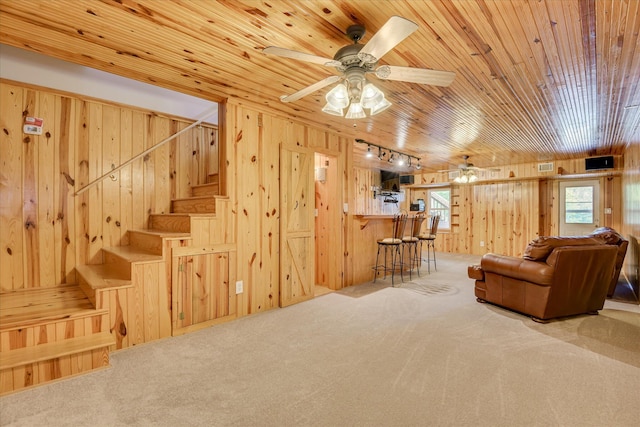 81 Two Mile Dr, Johnston, SC 29832 - carpeted living room with wood walls, wooden ceiling, ceiling fan, and stairs