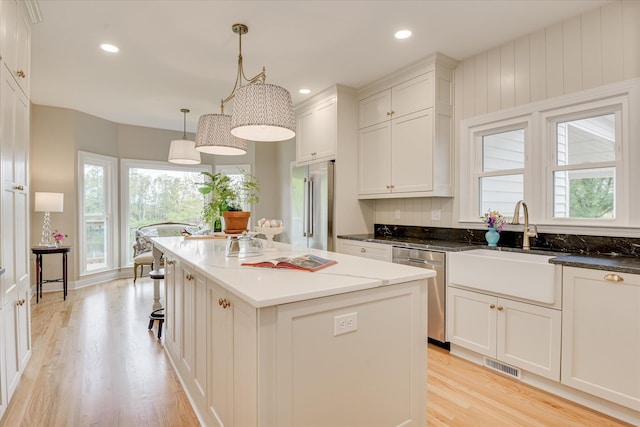 81 Two Mile Dr, Johnston, SC 29832 - kitchen featuring stainless steel appliances, light wood-type flooring, plenty of natural light, a kitchen island, and recessed lighting