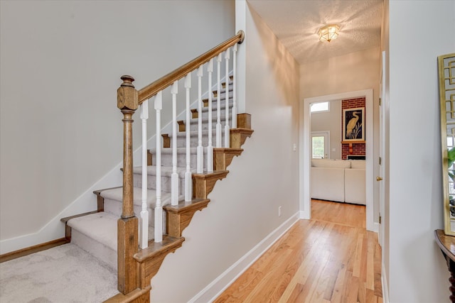 81 Two Mile Dr, Johnston, SC 29832 - staircase featuring wood finished floors and a textured ceiling