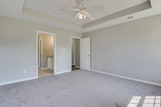 4620 Country Glen Cir, Grovetown, GA 30813 - unfurnished bedroom with a tray ceiling, light colored carpet, baseboards, and connected bathroom