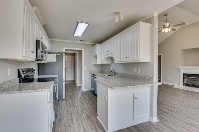 4620 Country Glen Cir, Grovetown, GA 30813 - kitchen with stainless steel appliances, a sink, light wood finished floors, white cabinetry, and vaulted ceiling