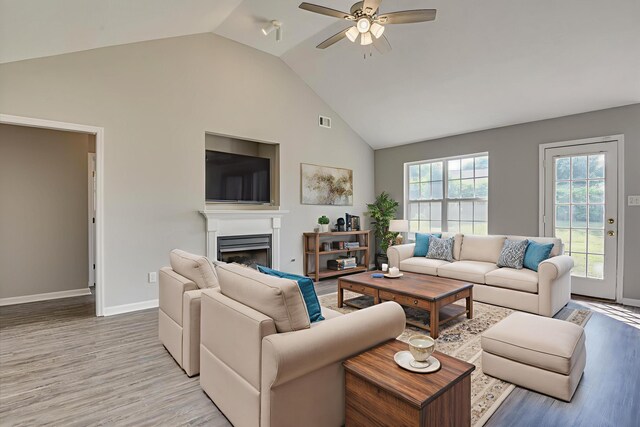4620 Country Glen Cir, Grovetown, GA 30813 - living area featuring light wood-style floors, a fireplace, a ceiling fan, baseboards, and high vaulted ceiling