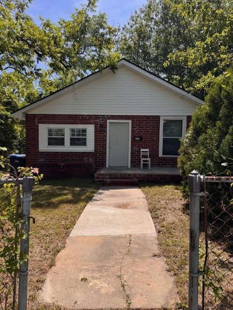 bungalow-style house with brick siding