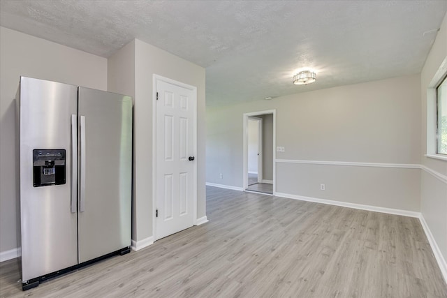 1608 Cider Ln, Augusta, GA 30906 - kitchen featuring stainless steel fridge, light wood-style floors, baseboards, and a textured ceiling