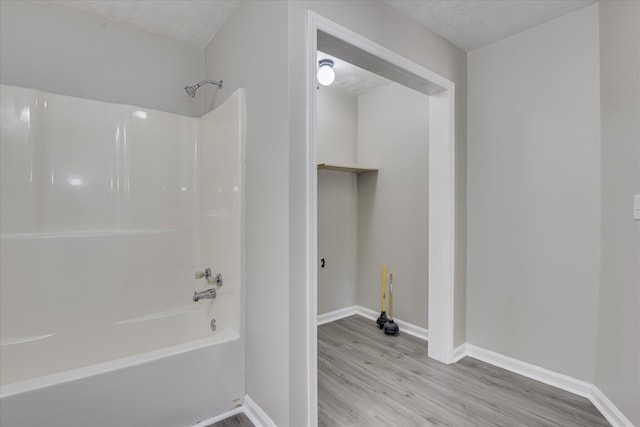 1608 Cider Ln, Augusta, GA 30906 - bathroom with wood finished floors, bathtub / shower combination, baseboards, and a textured ceiling