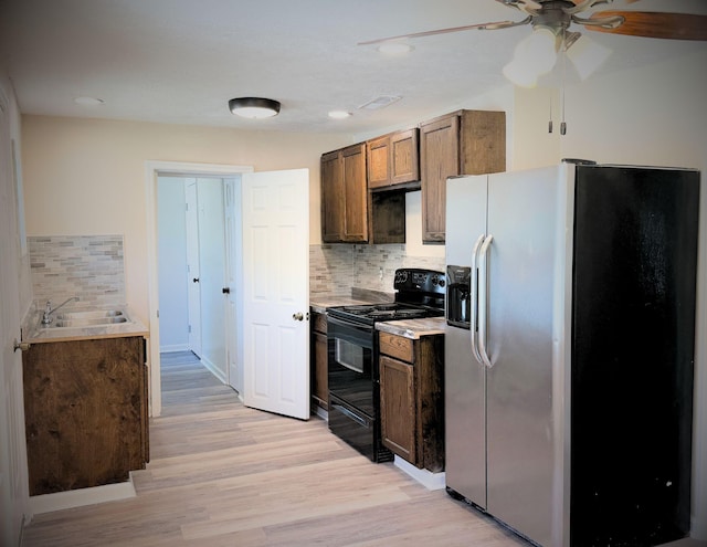 1431 Perry St, Augusta, GA 30901 - kitchen with stainless steel fridge with ice dispenser, electric range, backsplash, ceiling fan, and light wood-type flooring