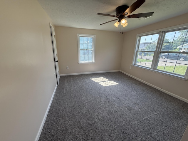 1431 Perry St, Augusta, GA 30901 - empty room with healthy amount of natural light, ceiling fan, dark colored carpet, and a textured ceiling