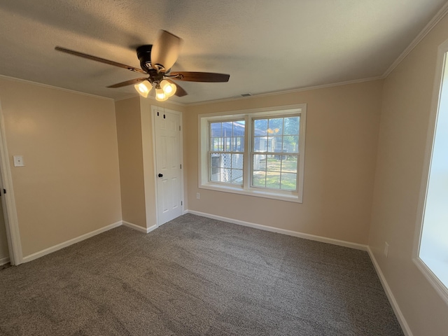 1431 Perry St, Augusta, GA 30901 - spare room with a ceiling fan, dark carpet, a textured ceiling, and crown molding