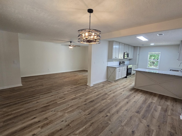 469 Lawrence Dr, Evans, GA 30809 - kitchen featuring appliances with stainless steel finishes, wood finished floors, light countertops, a ceiling fan, and open floor plan