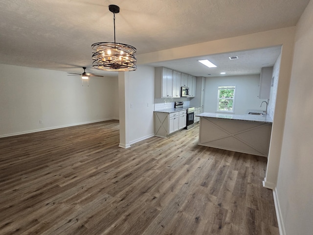 469 Lawrence Dr, Evans, GA 30809 - kitchen with stainless steel appliances, dark wood-style flooring, a chandelier, ceiling fan, and decorative backsplash
