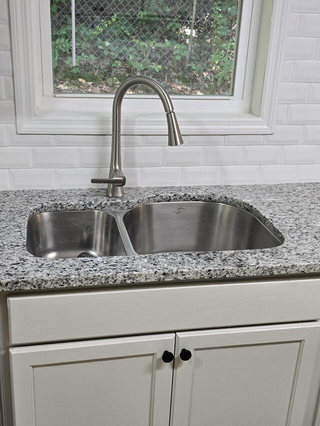 469 Lawrence Dr, Evans, GA 30809 - kitchen view of backsplash, light stone countertops, and white cabinets