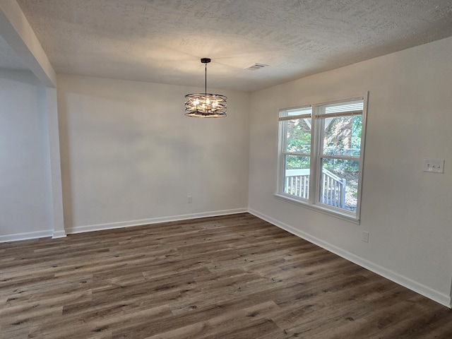 469 Lawrence Dr, Evans, GA 30809 - empty room featuring a textured ceiling, dark wood-style flooring, and a chandelier
