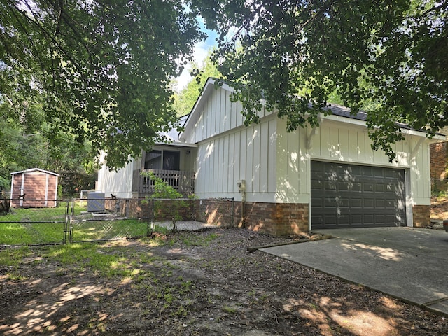 469 Lawrence Dr, Evans, GA 30809 - view of side of home featuring board and batten siding, concrete driveway, a gate, and an attached garage