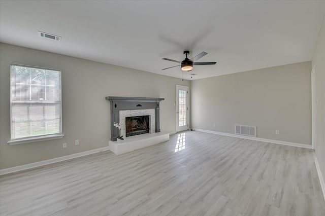 4171 Arlington Rd, Evans, GA 30809 - unfurnished living room featuring light wood-style flooring, ceiling fan, and a fireplace with raised hearth