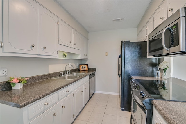 4171 Arlington Rd, Evans, GA 30809 - kitchen featuring stainless steel appliances, dark countertops, white cabinetry, light tile patterned flooring, and open shelves