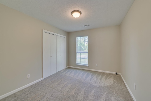 4171 Arlington Rd, Evans, GA 30809 - unfurnished bedroom with carpet, a textured ceiling, and a closet