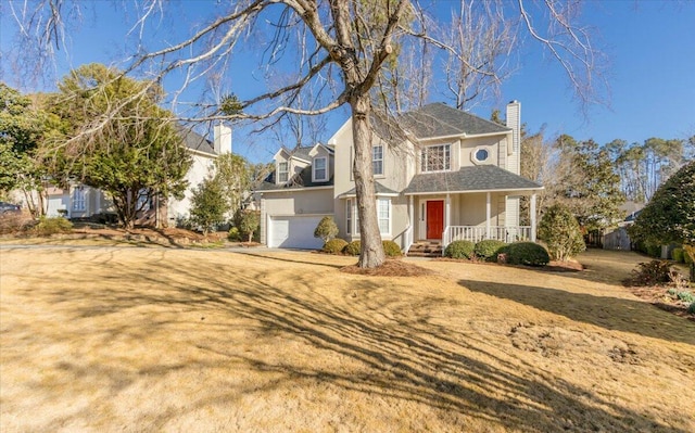 view of front facade featuring a garage, covered porch, and a front lawn