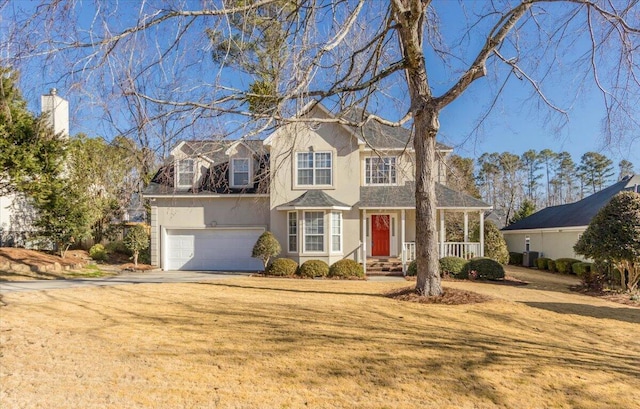 cape cod house with a porch, a garage, and a front lawn