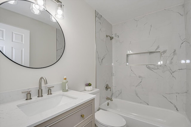 full bathroom with tiled shower / bath, vanity, and toilet