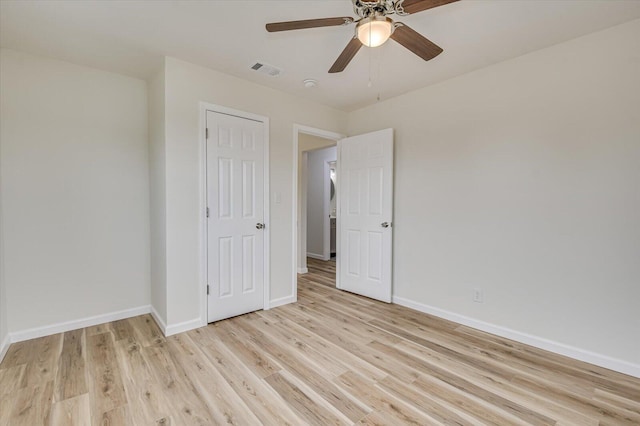 unfurnished bedroom with ceiling fan and light wood-type flooring