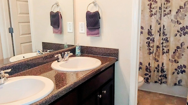 bathroom with walk in shower, vanity, and toilet