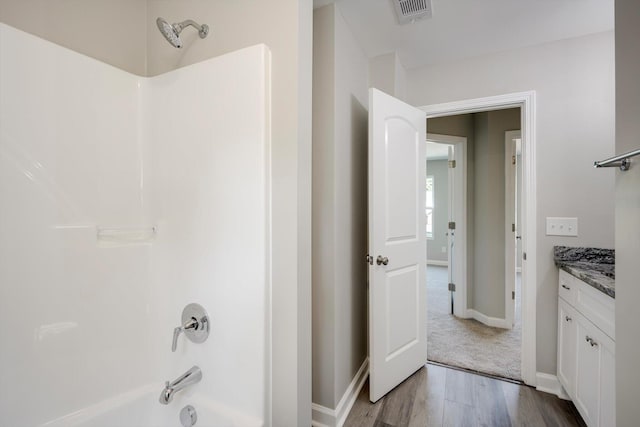 3605 Pebble Creek Dr, Hephzibah, GA 30815 - bathroom with shower / washtub combination, vanity, wood finished floors, and baseboards