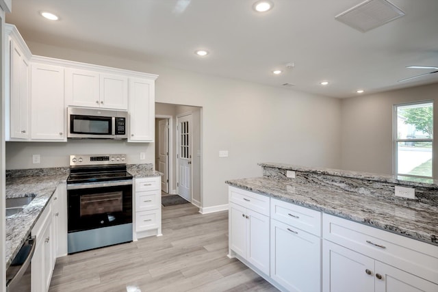 3605 Pebble Creek Dr, Hephzibah, GA 30815 - kitchen featuring stainless steel appliances, white cabinets, light wood finished floors, light stone countertops, and recessed lighting
