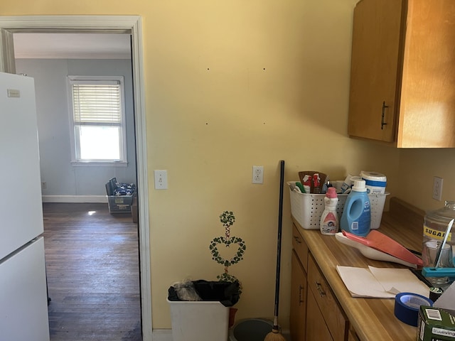 303 Spruce St, Louisville, GA 30434 - kitchen with baseboards, wood finished floors, crown molding, and freestanding refrigerator