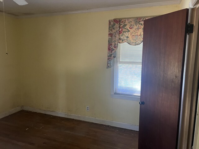 303 Spruce St, Louisville, GA 30434 - spare room with dark wood-type flooring, baseboards, and crown molding